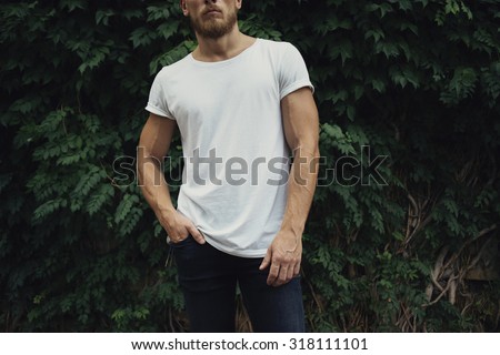 young man in white t-shirt with copy space. Front view