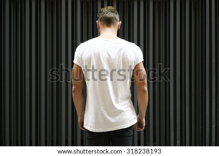 muscle young man with blank black t-shirt, back