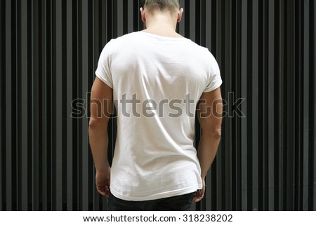 blank white t-shirt on muscle young man, black wall background