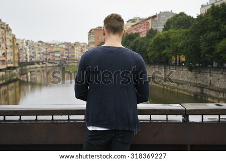 young hipster stands with his back to the camera. copyspace
