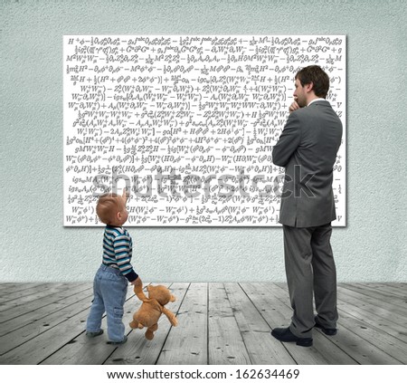 Small boy with businessman looking at board with mathematic formulas.