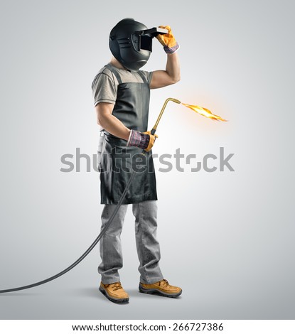 Similar – Image, Stock Photo A man welder with construction gloves and a welding mask hard work and welds with a welding machine metal in workshop, close up