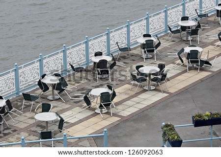 Deserted seaside tables on cold winter weekend in Mumbles