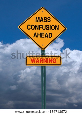 conceptual sign mass confusion ahead and danger warning over blue sky