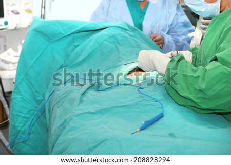 Nurse with gloves cutting a patch for a patient wound after surgery.  Focus in the gloves.