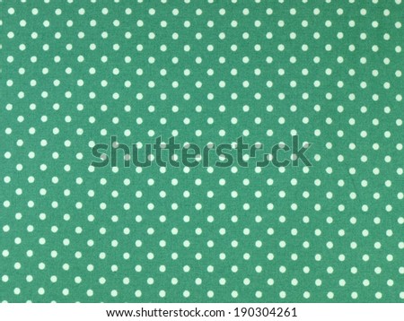 Seamless white and green polka dots fabric background