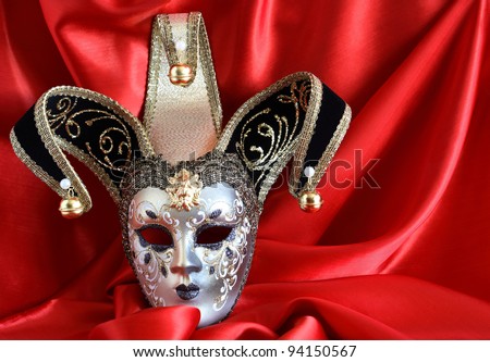 Closeup of classical venetian mask on red silk background
