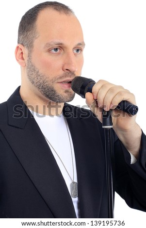 man holding a microphone in his left hand and says