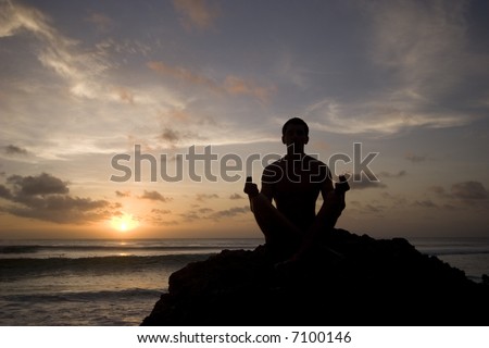 Silhouette of a meditating man.
