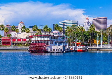 Rainbow Harbor with city skyline, boats and paddle wheel boat at Long Beach , CA
