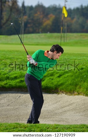 Golfer chipping the ball from sand trap
