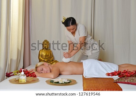 Thai massage, Young beautiful female receiving herbal ball massage