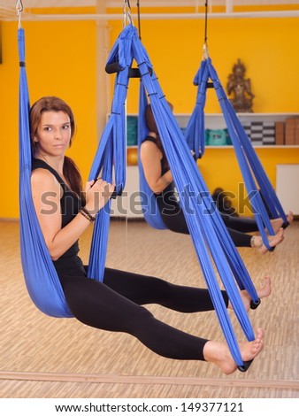 Woman doing anti gravity Aerial yoga exercise