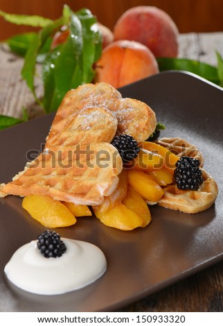Belgian waffles with fresh peaches and ice cream