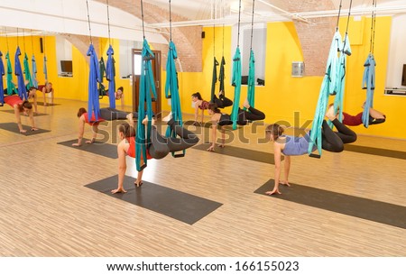 Women doing anti gravity Aerial yoga exercise in the gym