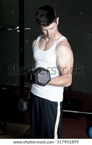 Fitness Trainer training his biceps at the gym