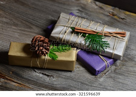 Stylish & rustic christmas gifts box presents on the old wooden table