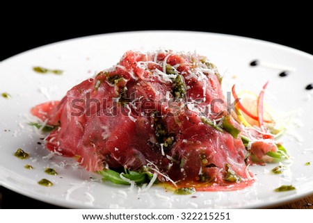 Fine dining, Beef carpaccio with pesto genovese, parmesan cheese, capers and rocket salad
