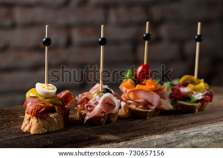 Tapas on Crusty Bread - Selection of Spanish tapas served on a sliced baguette. Foto stock © 