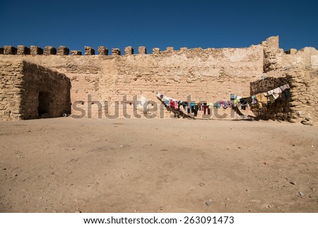 Backyard of typical Moroccan Berber house with drying cloths in the front