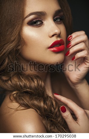 Sexy Beauty Girl with Red Lips and Nails. Provocative Make up. Luxury Woman with Blue Eyes. Gorgeous Woman Face. Long Hair