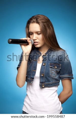 Beautiful young girl on a bright background. Music theme.