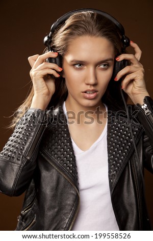 Beautiful young girl on a bright background. Music theme.