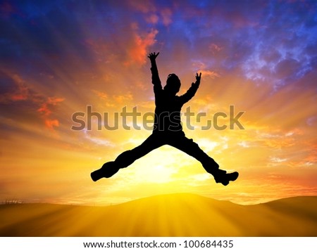 man jumping on a sunset background
