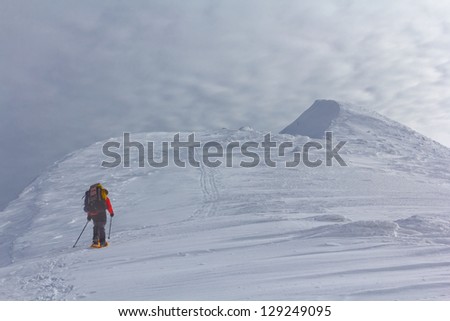 tourist walk among a winter mountains