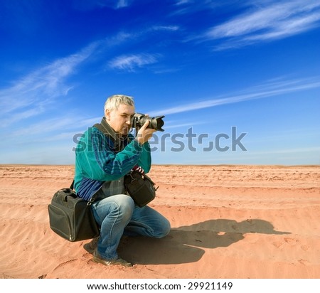 photographer with a camera in the desert