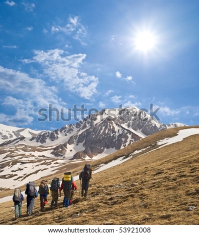tourist group walking to a mountain pass