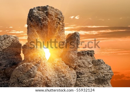 sun rays pushing through a rock