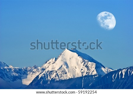 moon above a mountain top