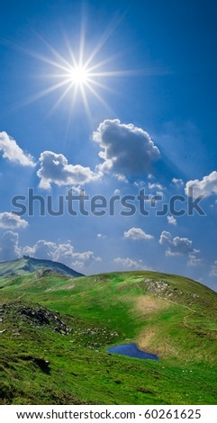 green mountains under a sparkle sun