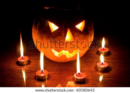 jack lantern in a dark among a candles