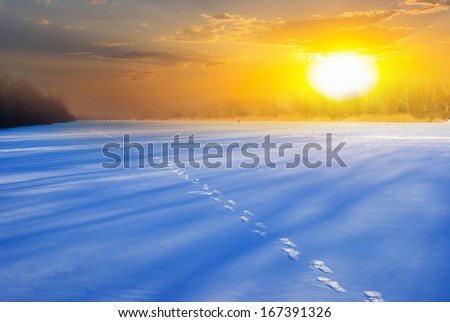 sunset over a winter snowbound plains