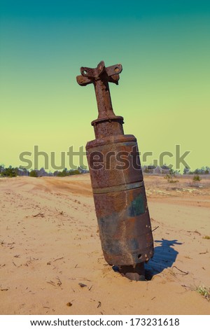 old rusty bom in a sand desert