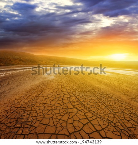 dry cracked earth at the sunset