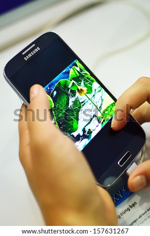 SAIGON, VIETNAM - OCTOBER 8 : Female hand holding the Samsung Galaxy S4, is a high-end, Android smartphone produced by Samsung Electronics, runs Android 4.2 in October 8, 2013