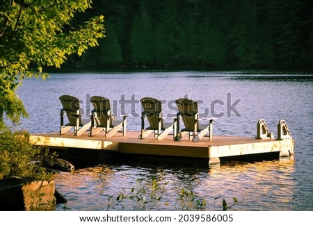 Four chairs in a wooden dock facing the lake Stock fotó © 
