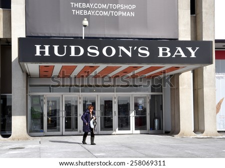 Toronto, Canada - February 24, 2015: A shopper walks fast in front of Hudson\'s Bay at Yorkdale Shopping Centre.