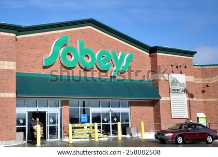 North Bay, Ontario, Canada - March 4, 2015: Shoppers goes out in front of Sobeys supermarket.