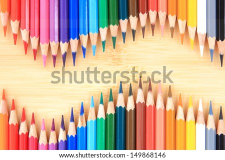 Picture Colour pencils on wood background close up