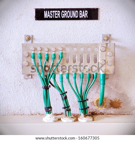 Old ground electric cables with master terminal bar.