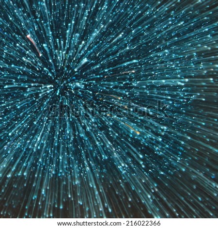 blue abstract explosion with glitter zoom bokeh lights background.