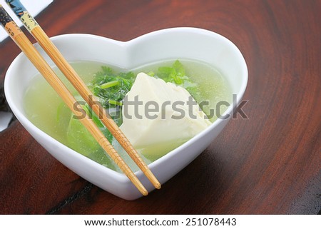 Tofu Lettuce  Miso Soup in white heart-shaped bowl with chopsticks.