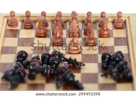 Chess king team leader dominating another in the foreground against a background of black army chips. isolated on white background.