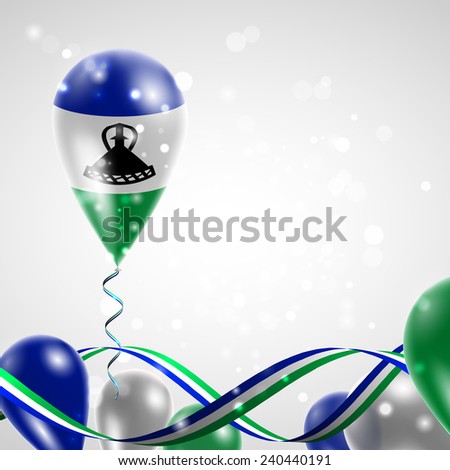 Flag of Lesotho on balloon. Celebration and gifts. Ribbon in the colors are twisted. Balloons on the feast of the national day. 