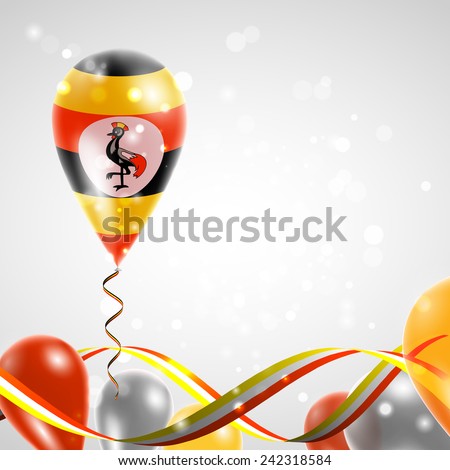 Flag of Uganda on balloon. Celebration and gifts. Ribbon in the colors are twisted. Balloons on the feast of the national day. 