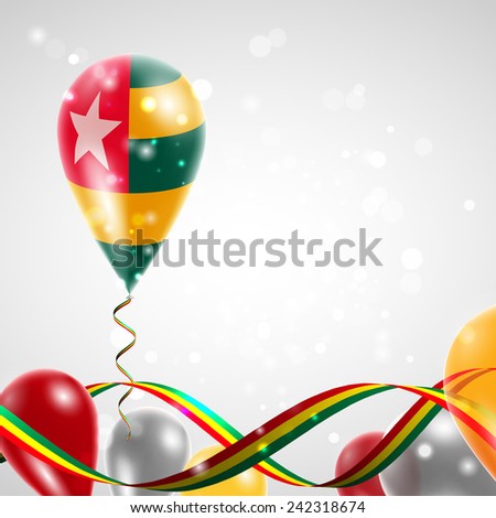 Flag of Togo on balloon. Celebration and gifts. Ribbon in the colors are twisted. Balloons on the feast of the national day. 